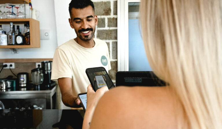 Barista accepting a payment in a coffee shop